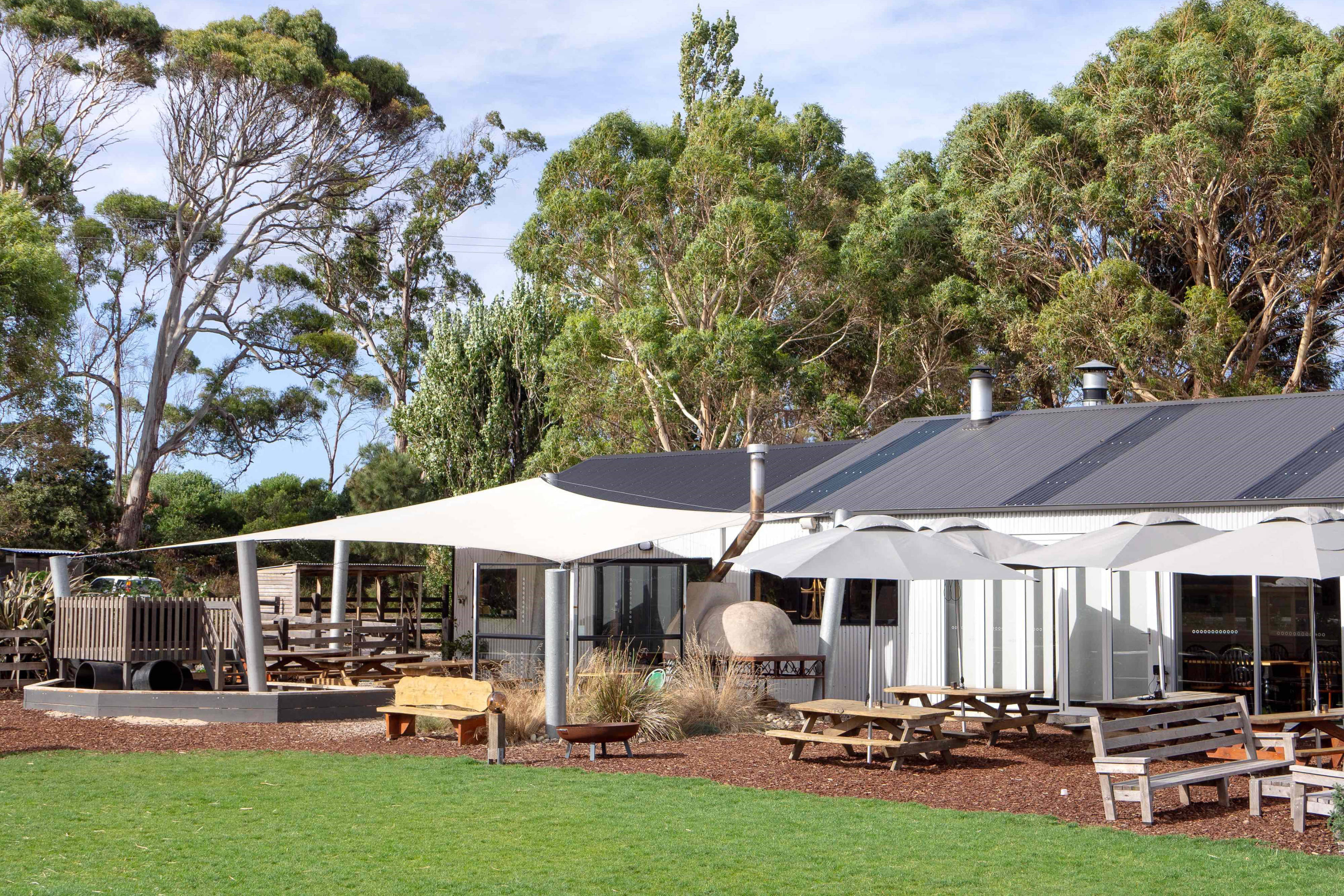 Outside of the Berry Patch shop / caf&eacute; building with outdoor seating and sun shades. Photo: The Berry Patch.